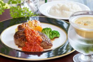 A plate of food and a glass of water on a table