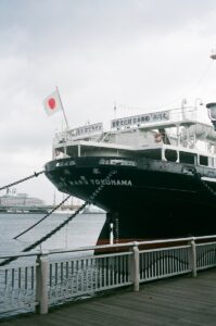 a large black and white boat docked at a pier