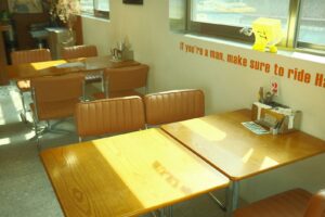 a table and chairs in a room with a sign on the wall