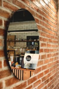 a brick wall with a circular mirror on it