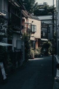 a person sitting on a bench in the middle of a street